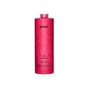 A tall, cylindrical bottle of Amika 'The Protector' hair growth strengthening shampoo, featuring a vibrant pink body with a subtle floral pattern and a translucent pink cap, set against a plain white background.