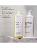 Two pump bottles of Olaplex No. 4 Bond Maintenance Shampoo and No.