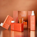 Kevin Murphy Chromatic Colour hair color product set with multiple bottles and boxes in a warm copper-orange color scheme, arranged on a reflective surface with a matching backdrop.