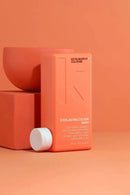 Red Kevin Murphy Everlasting Colour shampoo bottle on an orange background - Hair Care Canada