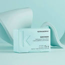 Kevin Murphy Easy Rider Defining Anti Frizz Crème in a light mint green rectangular box, styled with abstract white curved shapes on a matching light blue background.