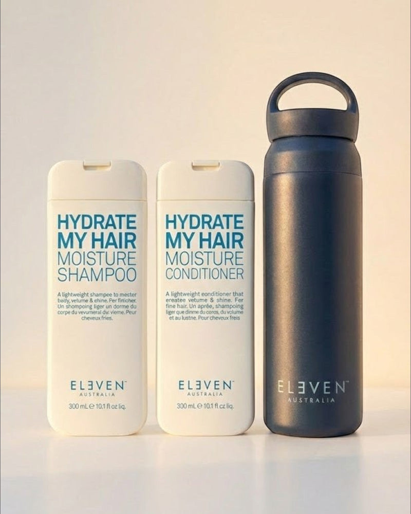 Set of 'Eleven Australia' hair care products including shampoo, conditioner, and a water bottle on a light background - Hair Care Canada